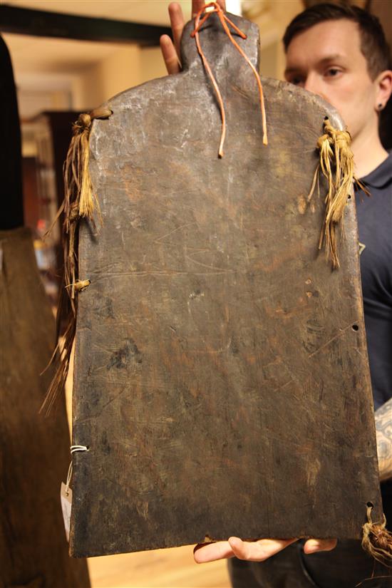 A Sepik River archers shield, another shield and three carved boards